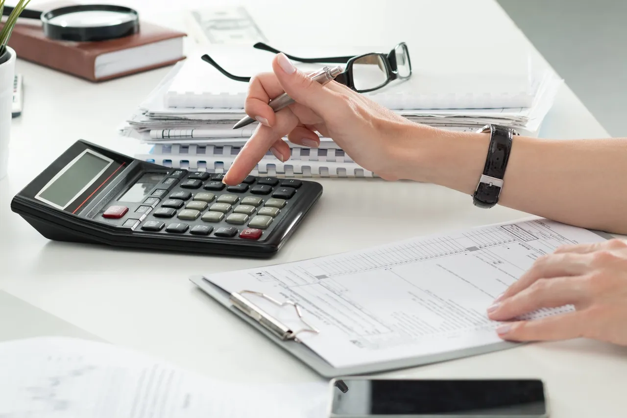 Accountant reviewing financial figures and spreadsheets.