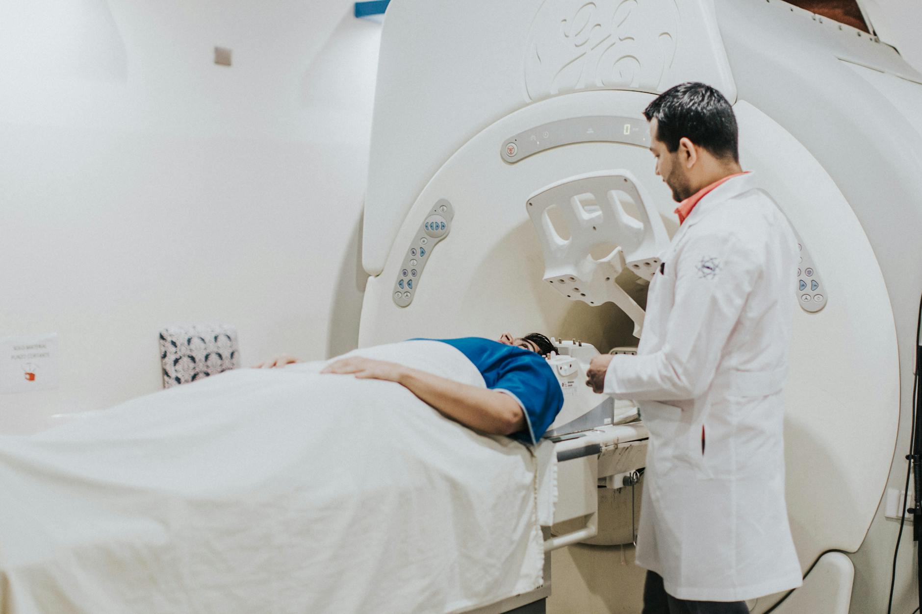 doctor examining patient on mri machine